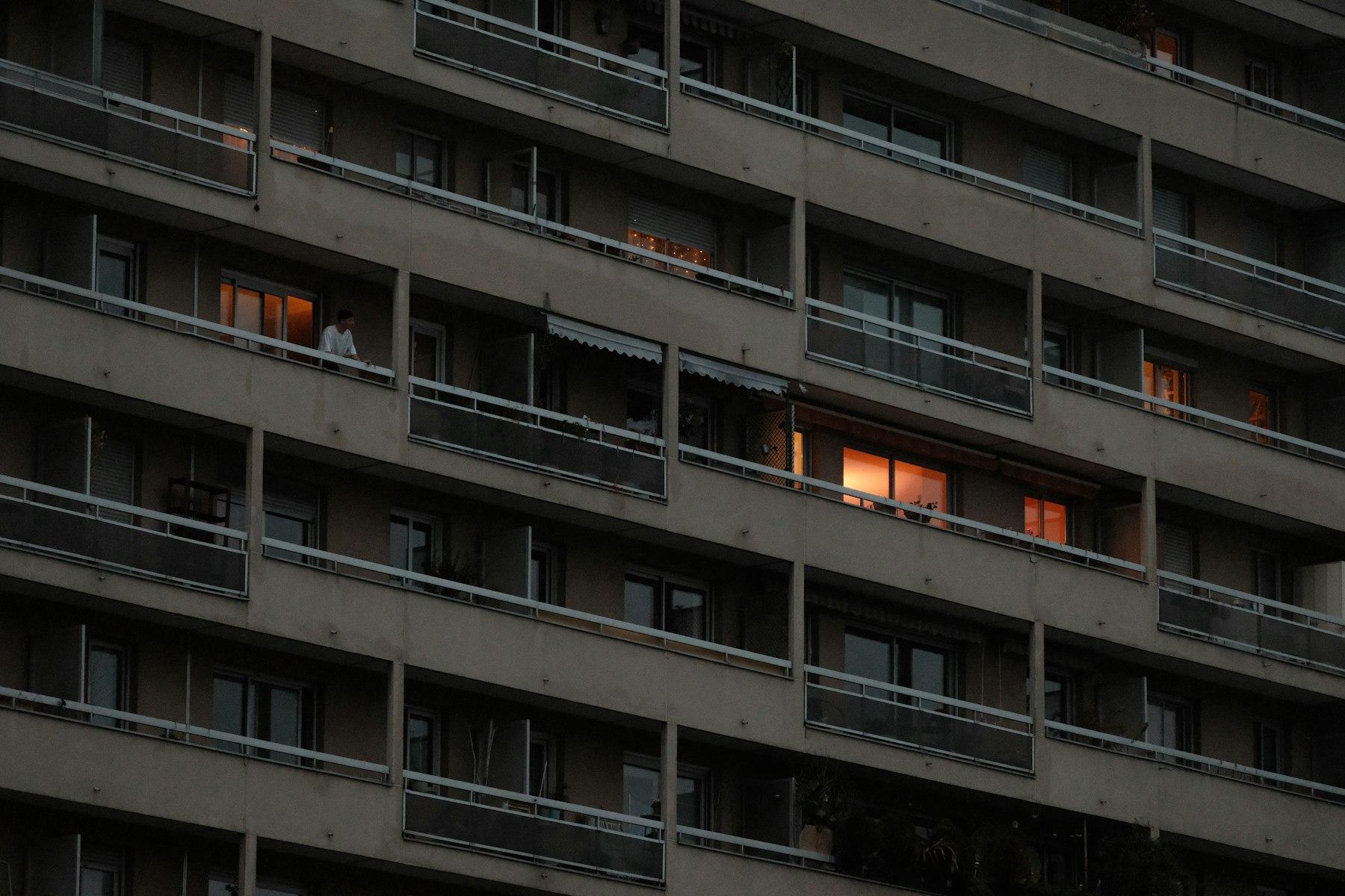 Modern architectural facade detail of a luxury residential tower in warm light