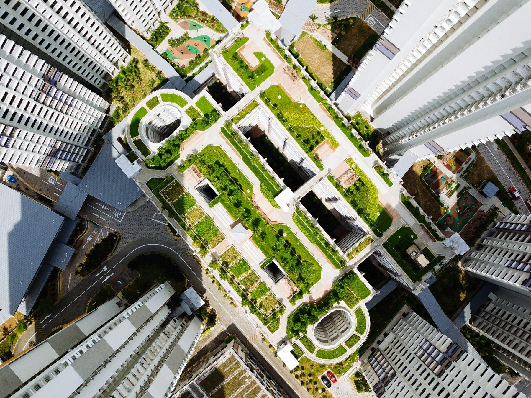 Aerial view of a master-planned township with high-rise towers surrounded by green landscaping